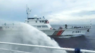 Philippines says ship hit by Chinese water cannon at disputed reef