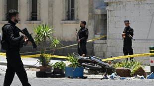 Syria says IS behind Damascus blasts, finds explosives cache
