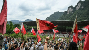 Explosions, red flags: Chinese tourists reenact communist victory