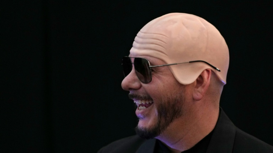 US rapper Pitbull sets bald cap world record at London show 